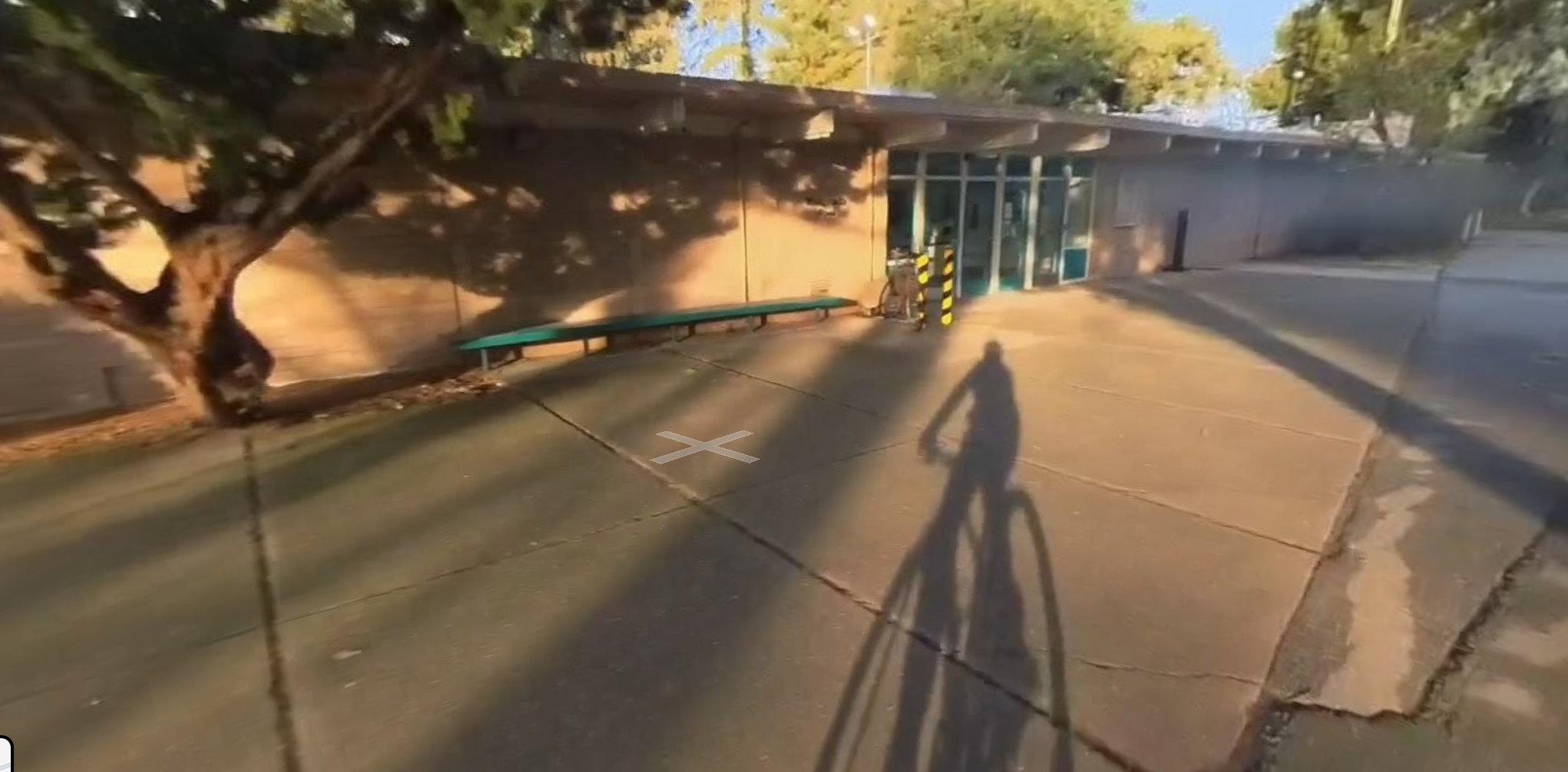 Rinconada Pool entrance showing the green benches where swimmers should meet before lessons.